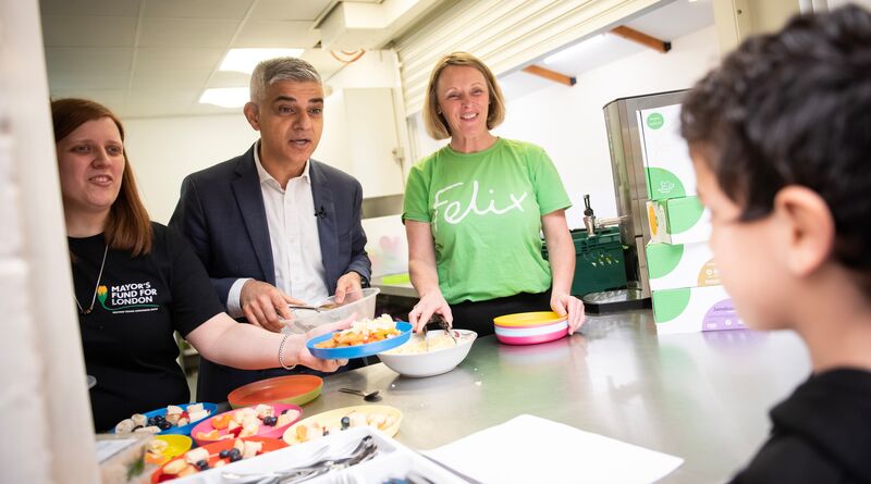 Sadiq serves free school meals to a child during the holidays.
