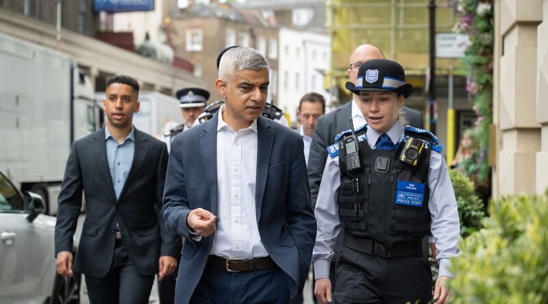 Sadiq walks with police through London's streets.