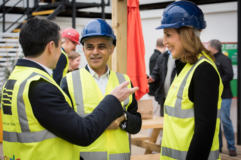 Sadiq wears hard hat and high vis on a construction site visit.